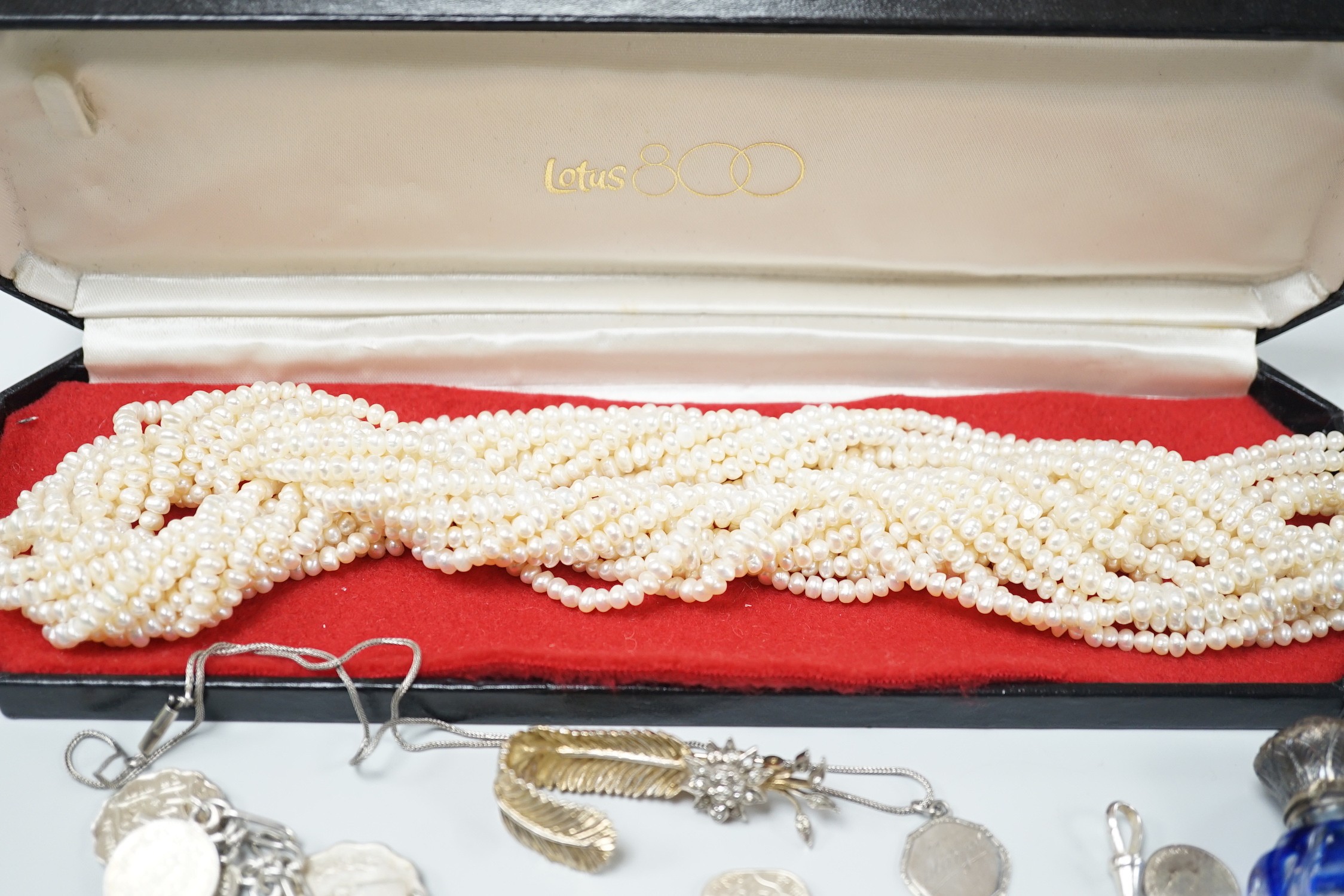 Mixed jewellery including a modern freshwater? pearl torsade necklace, 52cm, a Christian Dior 58 paste set brooch, two coin bracelets, a single strand cultured pearl necklace, mounted glass scent bottle, etc.